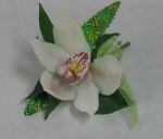 A single white cymbidium orchid with iridescent green leaves. This is a stunning and modern approach to the corsage or boutonniere.