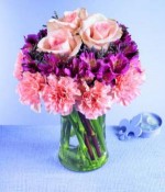 Pretty petals in a tiered design make a unique bouquet. Pink carnations form the first tier; deep lavender alstroemeria fill the center, and three luscious pink roses are the crowning touch. A stylish design for anyone who appreciates something above the ordinary.