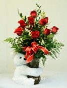 Lovely Valentine keepsake white bear 12 inches or 28cm.12 Red Freedom rose from Ecuador and mixed foliage. Cupid bow and heart pick.