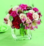 Pale pink spray roses are gently caressed by hot pink roses, burgundy carnations and pink alstroemeria in this sweet bouquet. Held in a clear rectangular glass vase. We use Demar sweetheart roses.