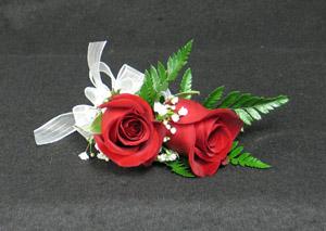 Two roses in a wristlet. We have other colours order early, please. Early being a week or 5 days just to be safe. We deliver as well.