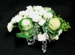 White kale and white roses in a low centre piece, with silver rope accents. We made this arrangement for the CANFAR dinner 2009.