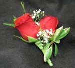 Two Roses and baby breath. For a prom, wedding, anniversary, or any special event. Hatcher Florist delivers.