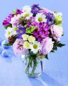 This bouquet  purple alstroemeria,  lisianthus, white daisies, and other soft blooms arranged in a glass vase expresses your Love or friendship.