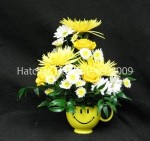 Smiley Face coffee, or tea mug. Perky fresh yellow Anastasia mums, white Daisies, and white and yellow spray Chrysanthemums,  mixed with our Sierra Eco Yellow Golden Gate roses from Denmar.