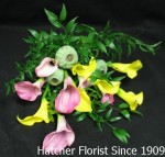 A bouquet of yellow, rusty red and limited pink calla lilies with greenery and mixed foliage. Nine stems of these petite jewels. Limited colour selection so order early, please.