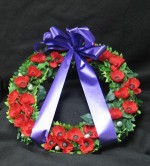 Artificial poppy wreath 16 inches in diameter. Will last for years if kept out of sever weather. Mounted on a plastic wrapped styrofoam base. Made with pride, and respect, for our fallen heros, and heroines.