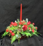 Centerpiece with B C Holly, seasonal Douglas fir, Cedar, White pine, red Freedom, Roses, red Miniature carnations, a red 15 inch candle, gold balls and pine cones.