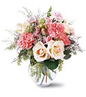 This sweet arrangement contains white roses, cream Versilia Roses, pink Snapdragons, pink Carnations, mixed foliage and Limonium. Flowers by Sierra Eco Toronto.