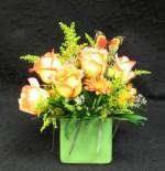 The growers in Holland named this rose Konfetti. Green ceramic cube with roses solidago and hardy chrysanthemums nestled into the arrangement to add depth.