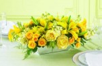 Perfect for any celebration, this golden centerpiece of yellow roses, yellow Asiatic lilies and creamy, fragrant Stock  or Snapdragons will bring a sophisticated touch to your table or buffet. Great for a Golden Wedding anniversary gift.
