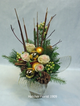 Golden Woodland a picture perfect combination of porcelina sweetheart roses, pine cone, cat tails, gold balls and Canadia pine and fir. designed in a rich golden ceramic container.