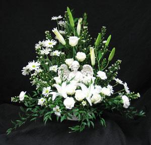 A mix of white flowers surround this kneeling Angel figure. A loving gift from a family member, or life long friend. Exclusive to Hatcher Florist. We deliver to Kane, Jerrett, Trull, Humphrey, Newbigging funeral homes as well as all the homes in the GTA and area.