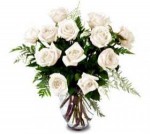 Twelve white Eskimo or Mondial Roses in a glass vase. Simply elegant. Send these Roses with all your best wishes. Pure white roses delivered from our flower shop.