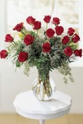18 roses, limonium and seeded eucalyptus are beautifully arranged in a glass vase. Sure to impress. Available in pink, red, yellow, white or peach. red Freedom roses by Sierra Eco.
